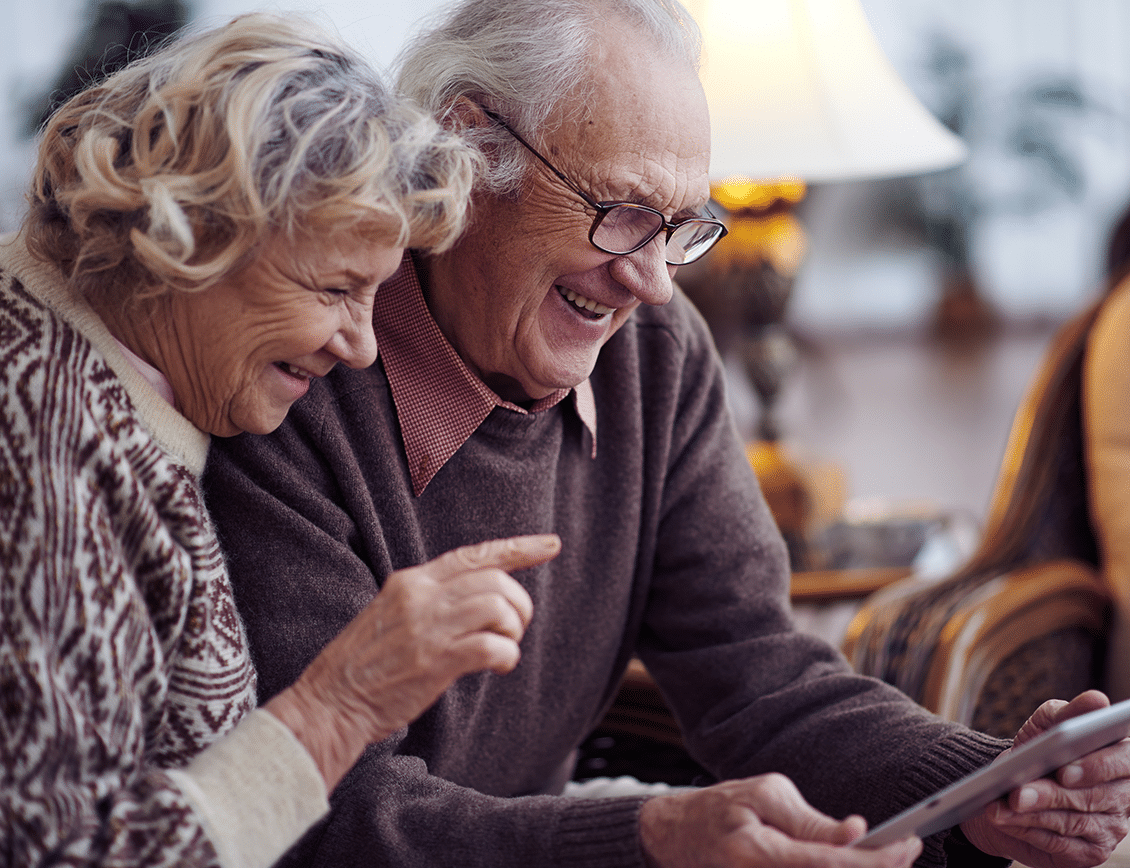 ae-fm-internal-1 two seniors navigate the Frontier Management website on a tablet