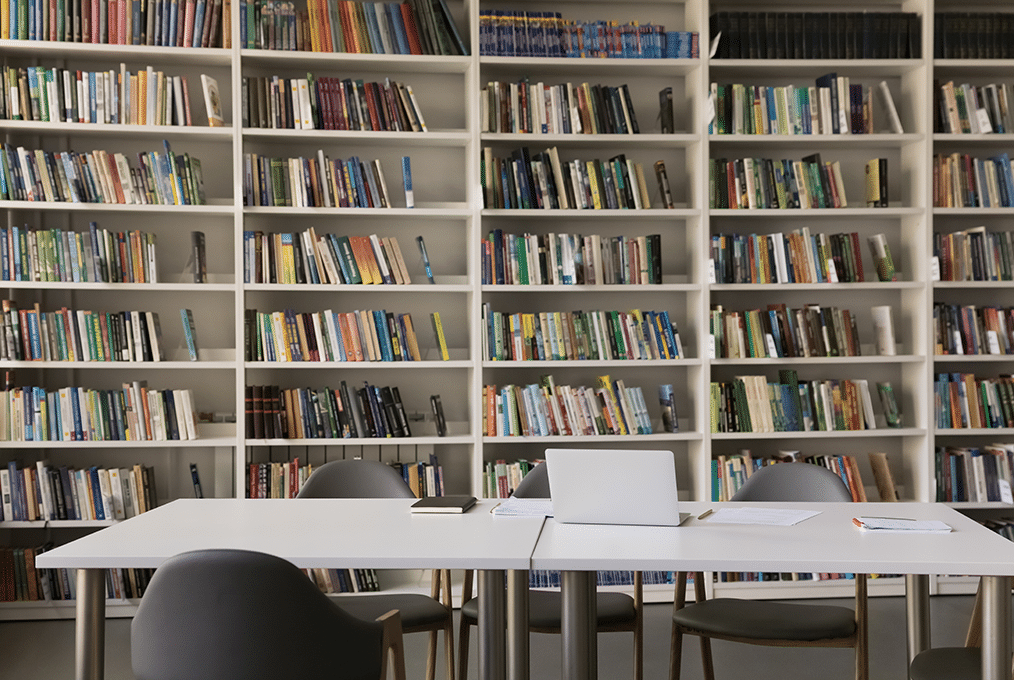georgian-college-interior-solution interior of a university library. a table sits in front of some bookshelves