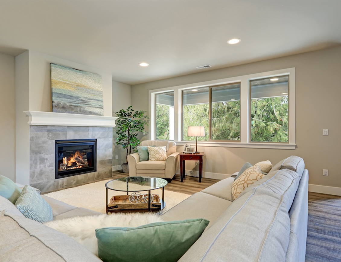 nhc2 Wpromote - The New Home Company case study: a new home living room with fireplace alight.